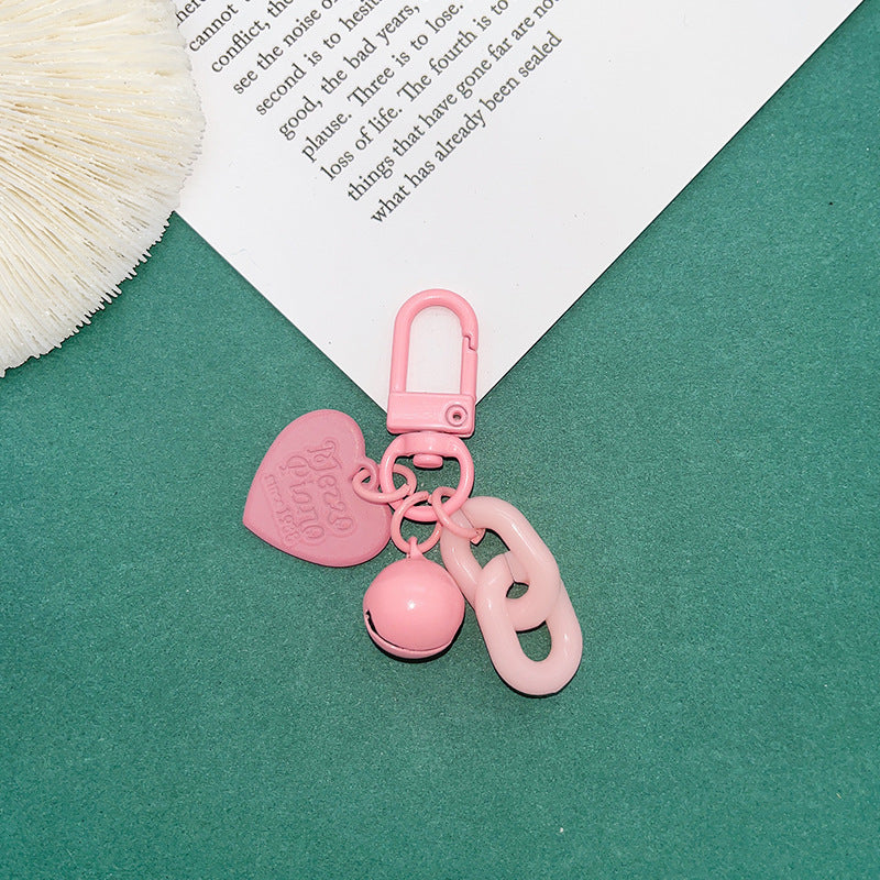 Venta al por mayor Llaveros de acrílico de campana pequeña de corazón de color caramelo