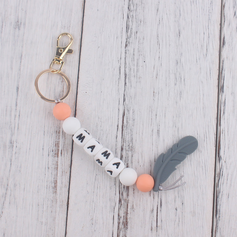 Llavero de plumas con cuentas de silicona colorida al por mayor