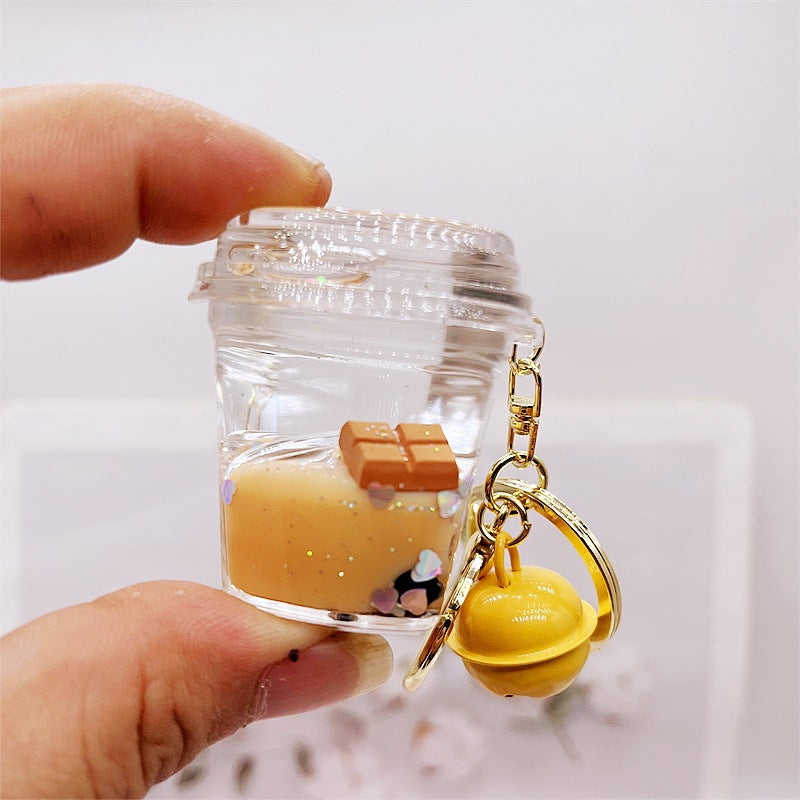 Comercio al por mayor acrílico flotando en el aceite de chocolate arenas movedizas llavero creativo