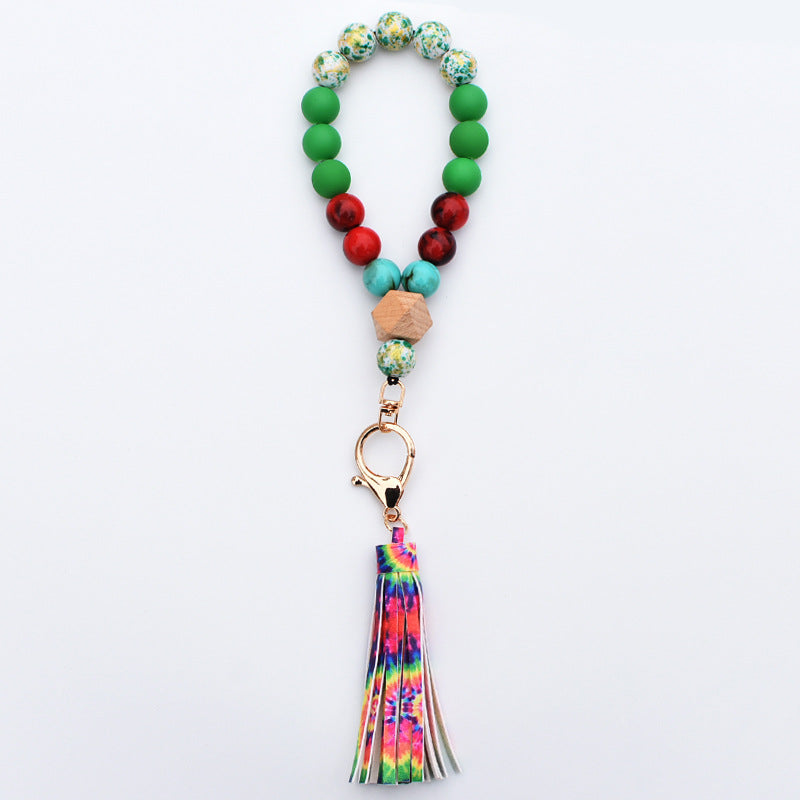 Comercio al por mayor de cuentas de madera PU impreso borla colgante muñeca llavero