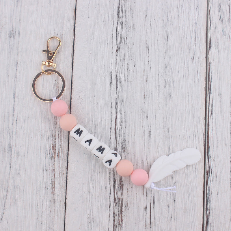 Llavero de plumas con cuentas de silicona colorida al por mayor
