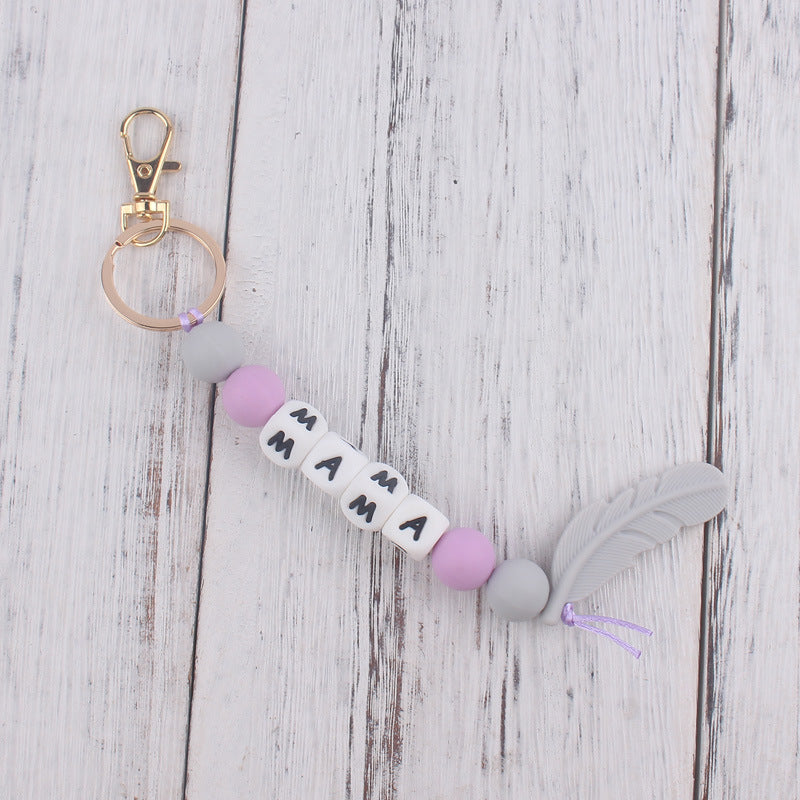 Llavero de plumas con cuentas de silicona colorida al por mayor