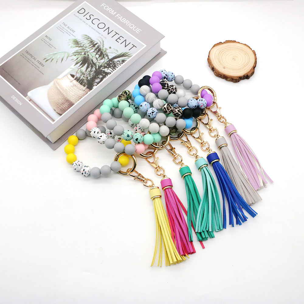 Venta al por mayor Llavero de la pulsera del grano del silicón de la borla