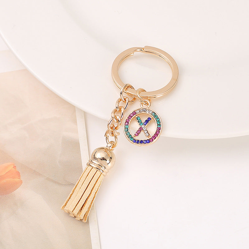 Venta al por mayor Llavero del alfabeto inglés de la borla de la aleación del cinc