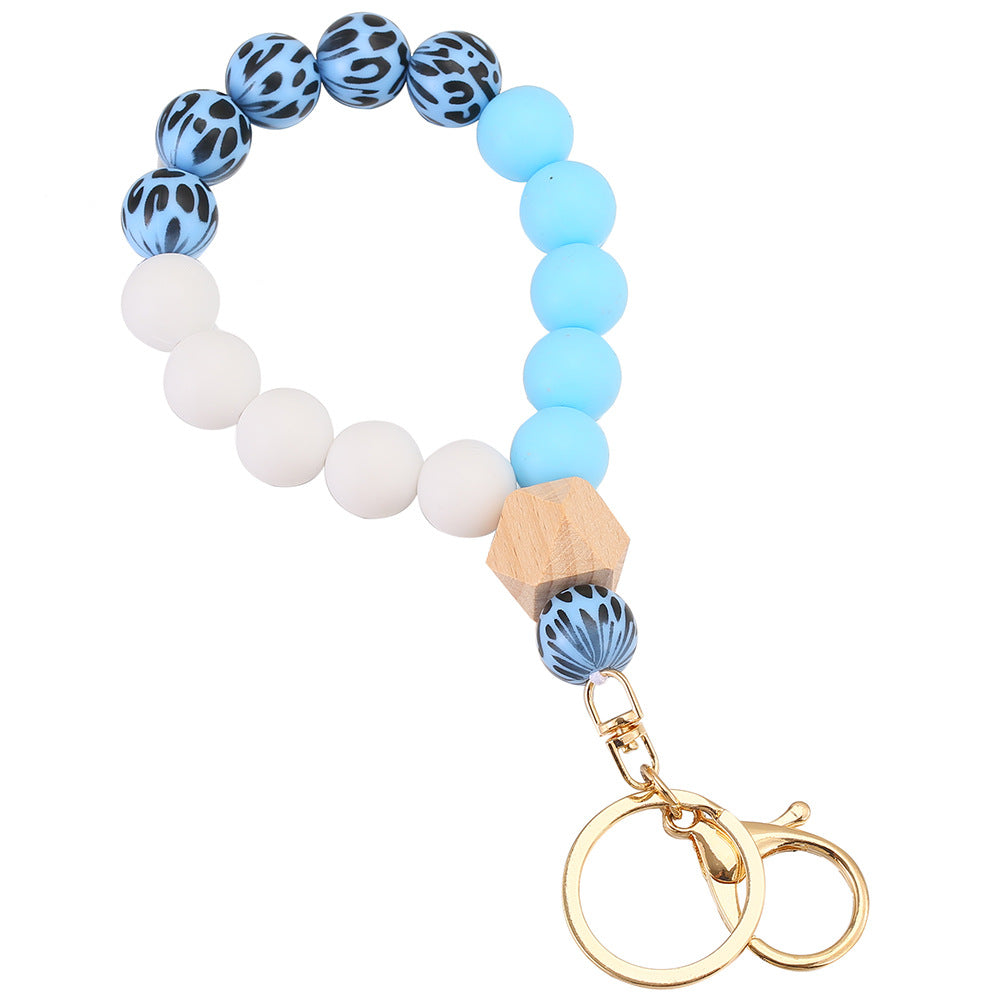 Llavero de muñeca con cuentas de madera de leopardo de leopardo.