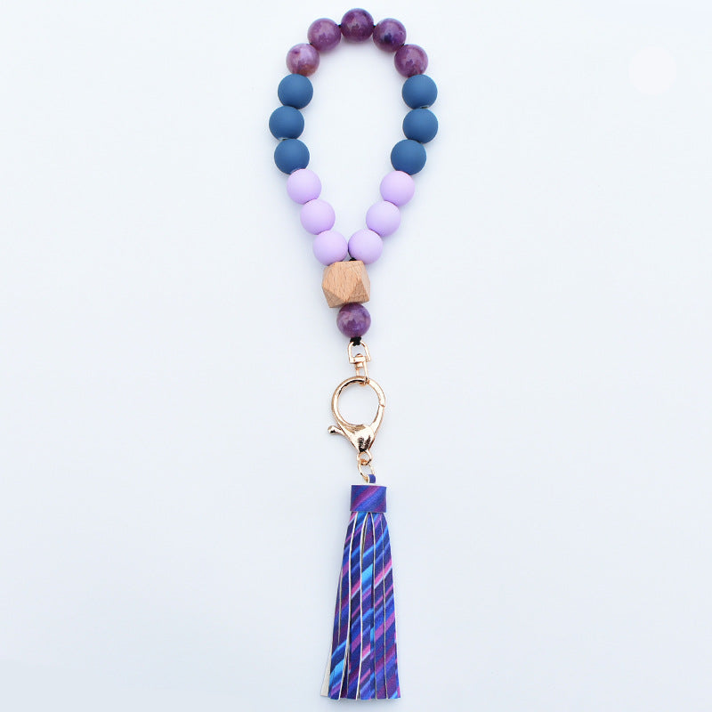 Comercio al por mayor de cuentas de madera PU impreso borla colgante muñeca llavero
