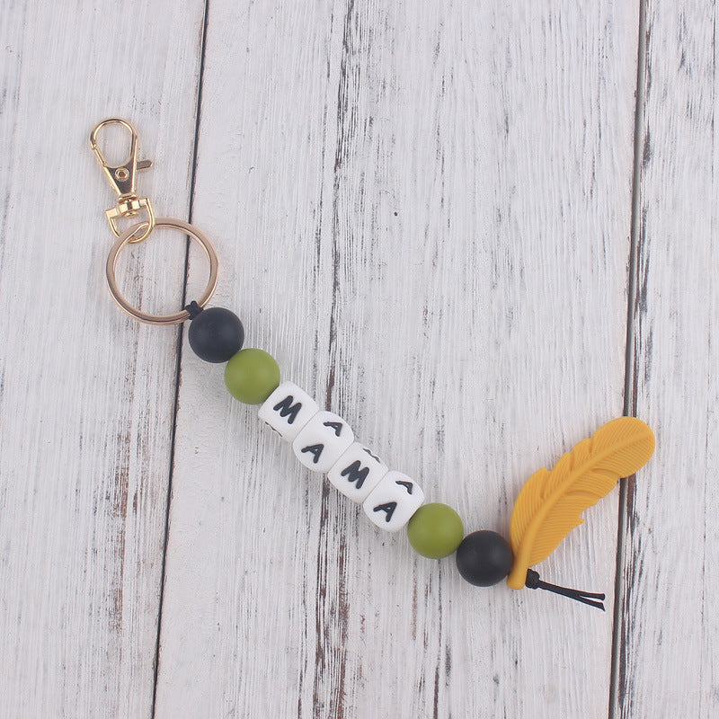 Llavero de plumas con cuentas de silicona colorida al por mayor