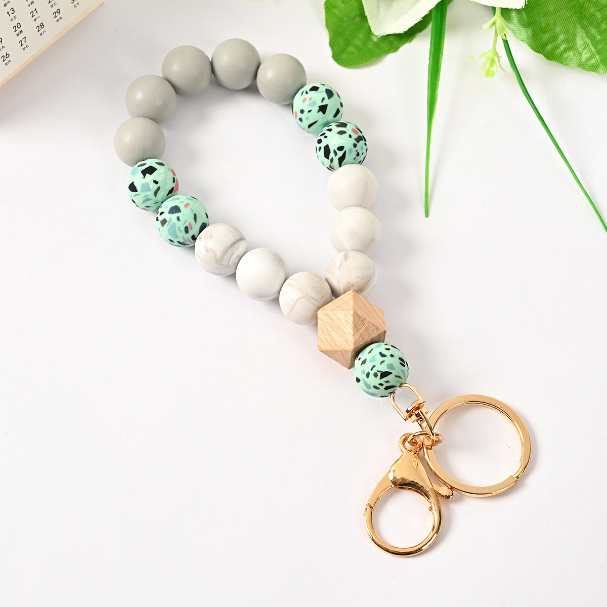 Venta al por mayor Llavero de la pulsera del grano del silicón de la borla