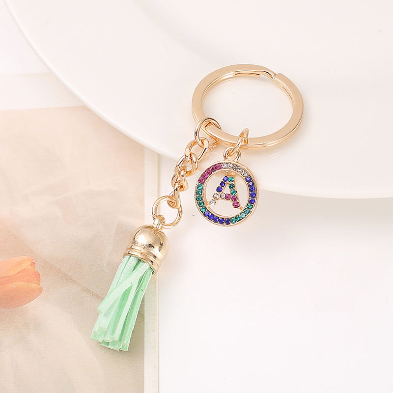 Venta al por mayor Llavero del alfabeto inglés de la borla de la aleación del cinc