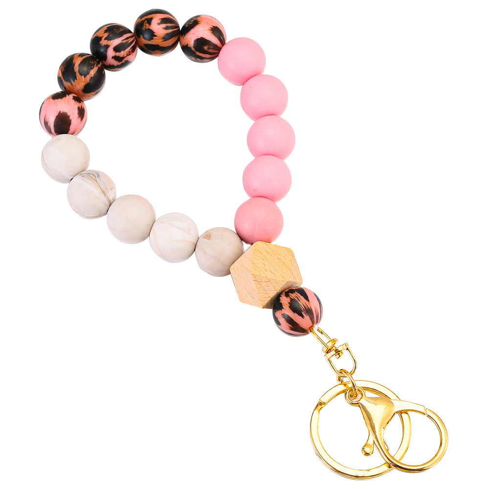 Llavero de muñeca con cuentas de madera de leopardo de leopardo.