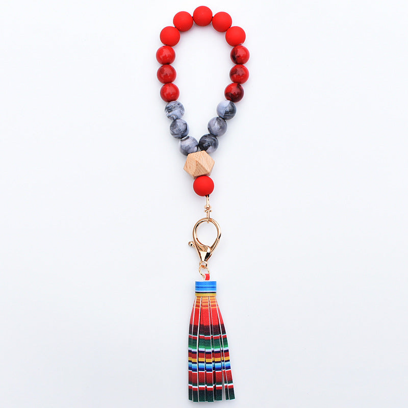 Comercio al por mayor de cuentas de madera PU impreso borla colgante muñeca llavero