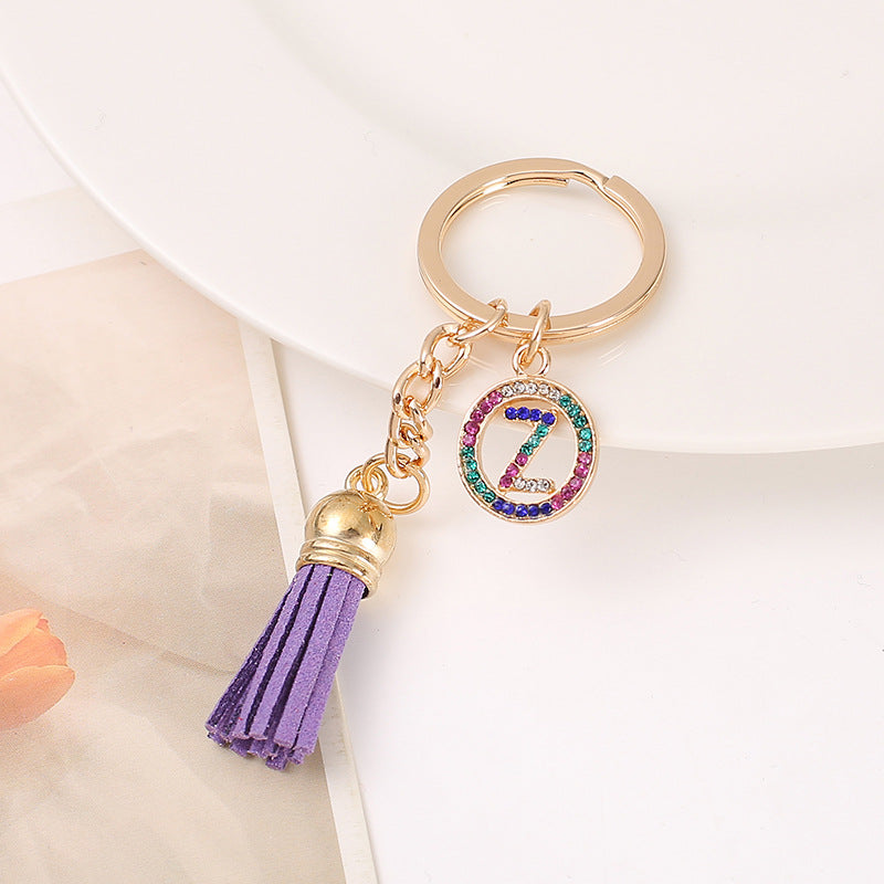 Venta al por mayor Llavero del alfabeto inglés de la borla de la aleación del cinc