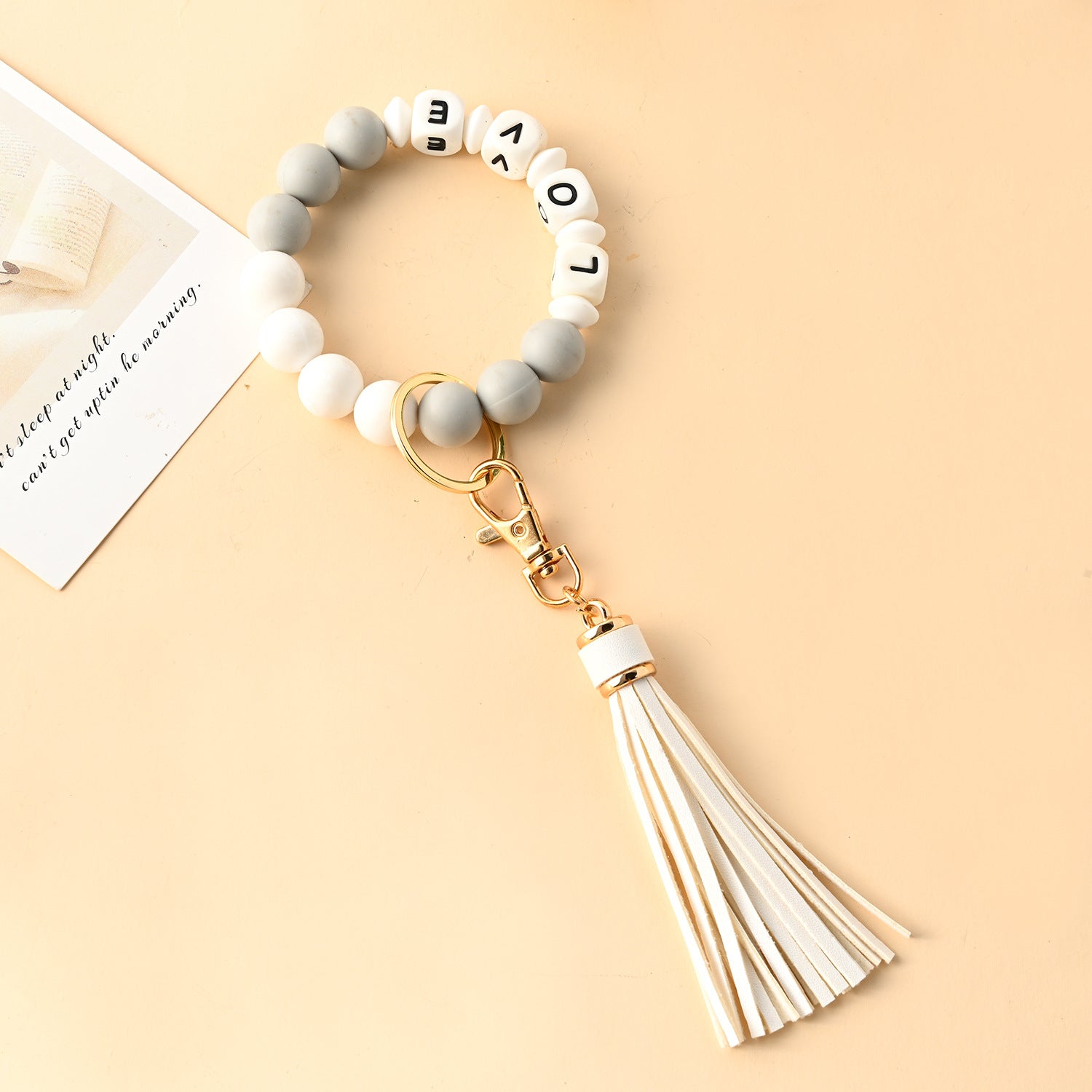 Venta al por mayor Llavero de muñeca con cuentas de silicona borla