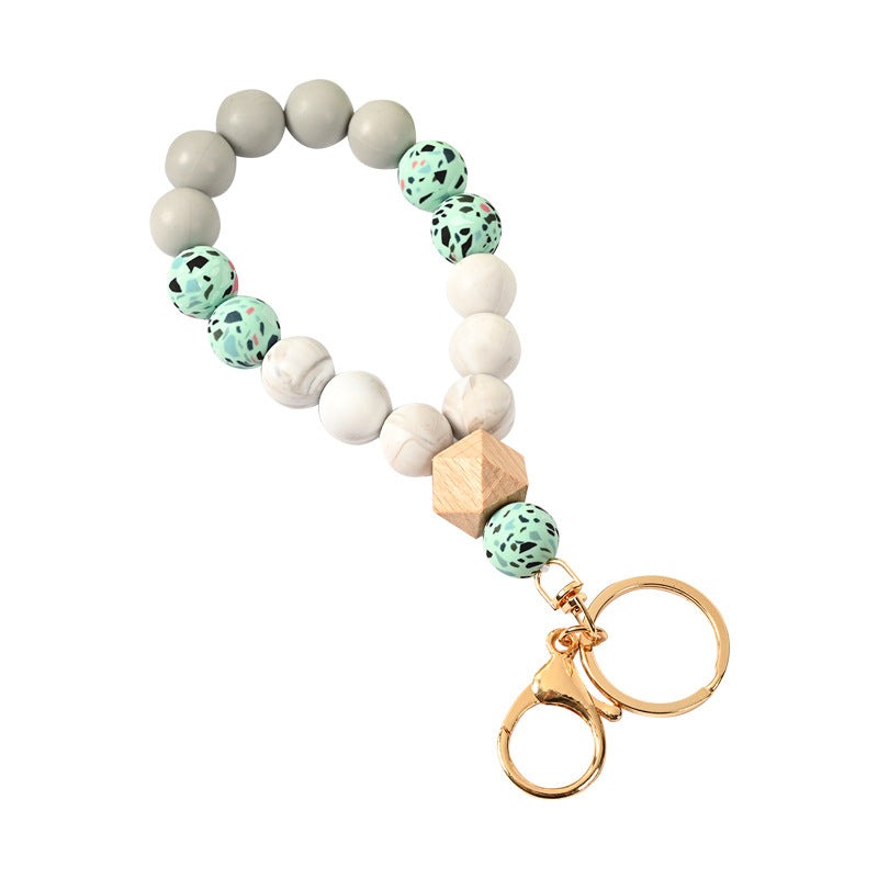 Venta al por mayor Llavero de la pulsera del grano del silicón de la borla