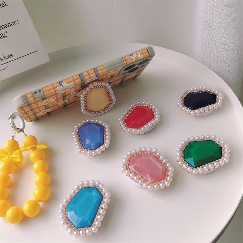 Venta al por mayor Soporte para teléfono móvil de perlas de piedras preciosas