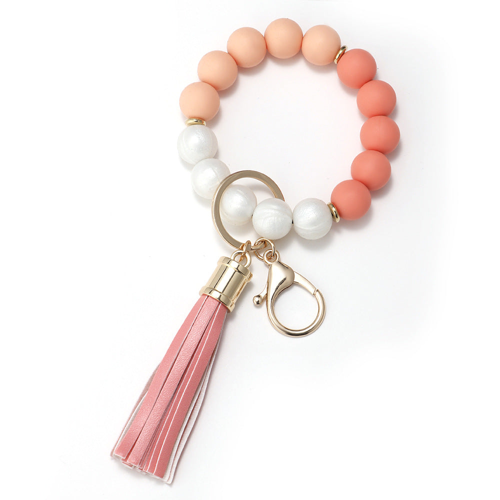 Venta al por mayor Llavero de muñeca de borla con cuentas de silicona