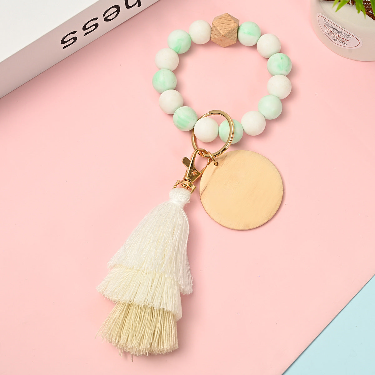 Venta al por mayor Llavero de la pulsera del grano del silicón de la borla