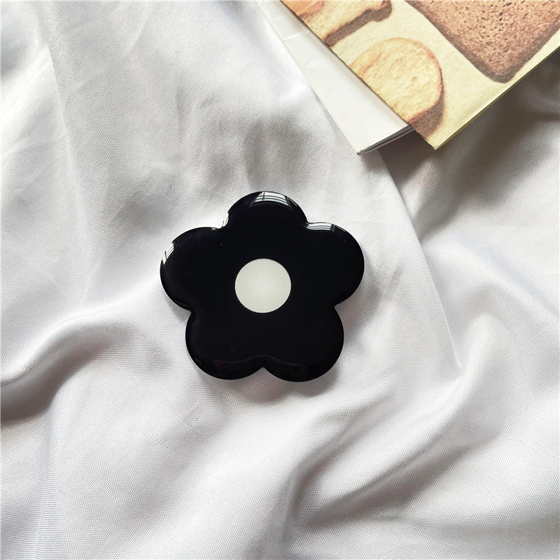 Venta al por mayor Torta de simulación Acrílico Airbag Soporte para teléfono móvil