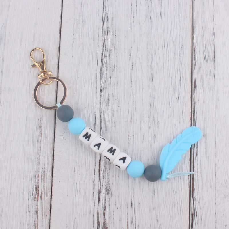 Llavero de plumas con cuentas de silicona colorida al por mayor