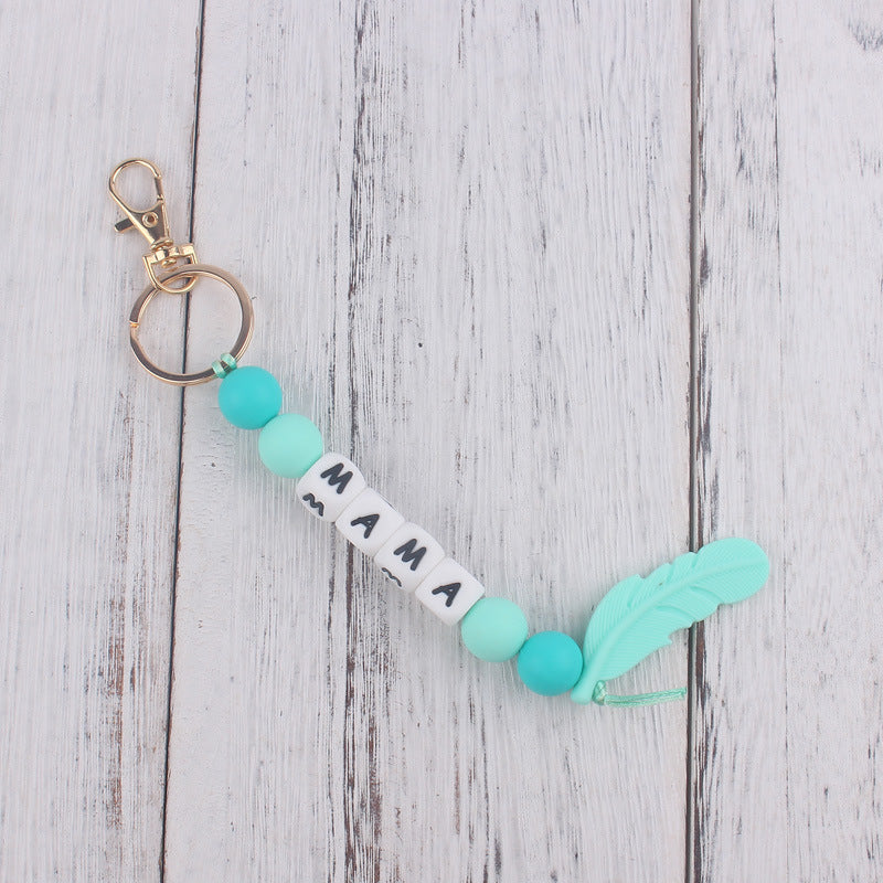 Llavero de plumas con cuentas de silicona colorida al por mayor