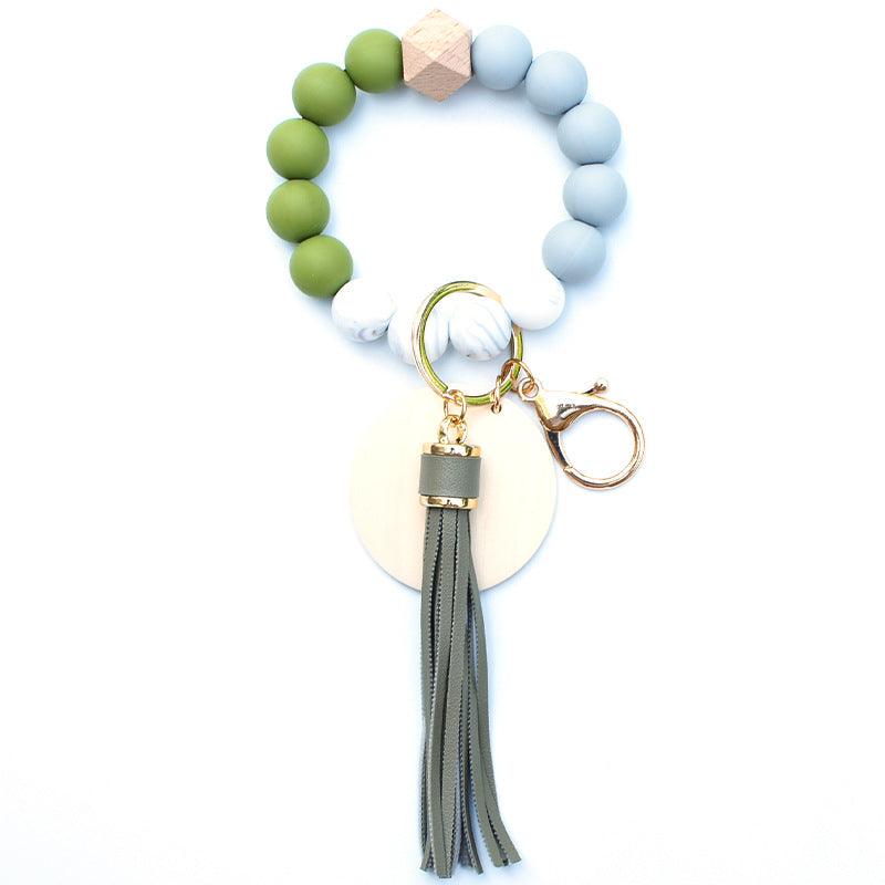 Llavero de muñeca de cuentas de madera con borla de silicona al por mayor