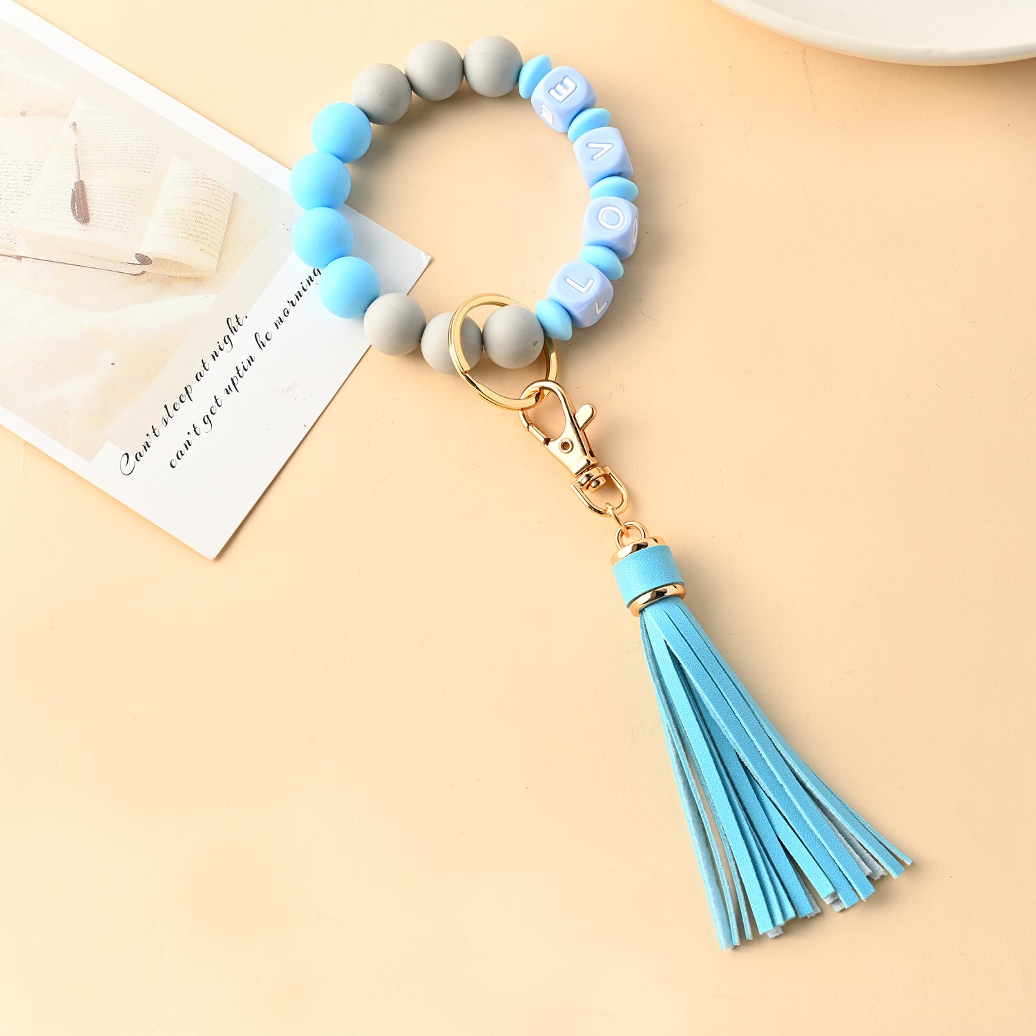 Venta al por mayor Llavero de muñeca con cuentas de silicona borla