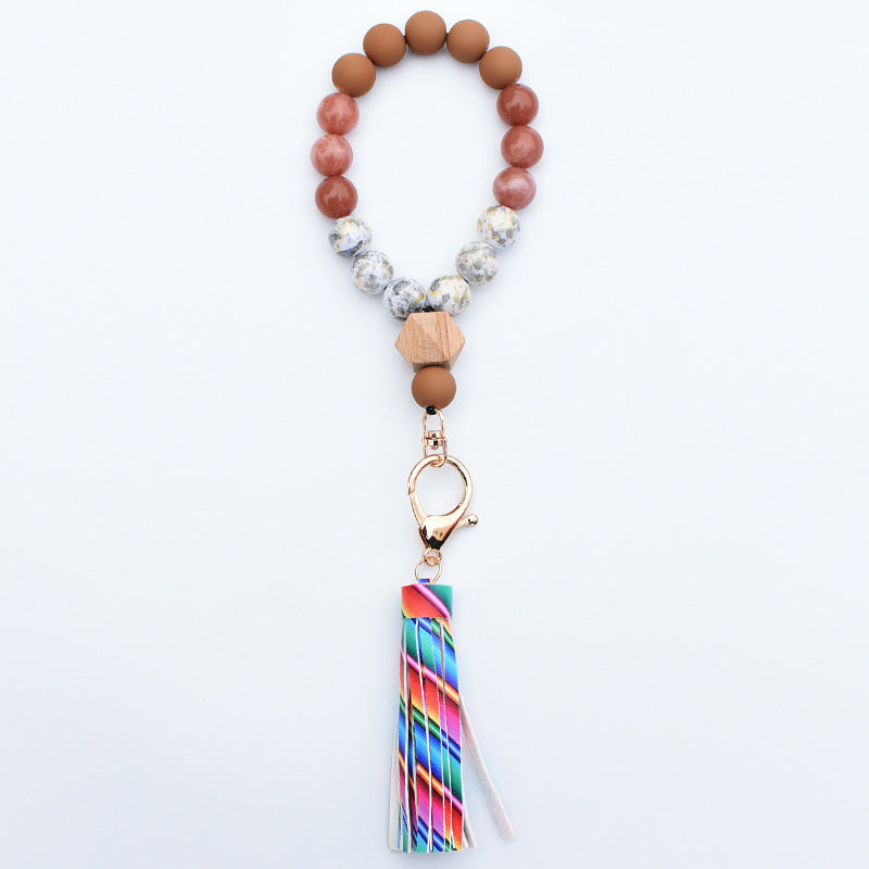 Comercio al por mayor de cuentas de madera PU impreso borla colgante muñeca llavero