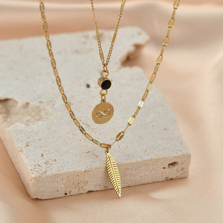 Venta al por mayor de acero inoxidable símbolo inalámbrico pluma diamante negro collar de doble capa